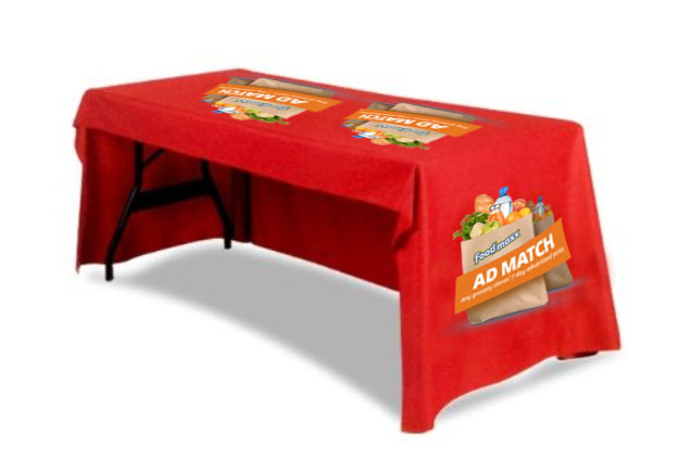 A table with a red printed cover of a brand